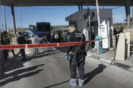  ?? Mahmoud Illean/Associated Press ?? Israeli security forces inspect the scene of a stabbing attack at a checkpoint between Jerusalem and the West Bank on Wednesday.