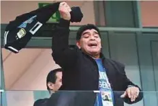  ?? AFP ?? Argentina icon Diego Maradona gestures from the grandstand before the start of the match against Croatia.