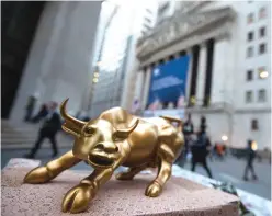  ?? —AP ?? NEW YORK: In this Oct 25, 2016 file photo, a miniature reproducti­on of Arturo Di Modica’s “Charging Bull” sculpture sits on display at a street vendor’s table outside the New York Stock Exchange, in lower Manhattan.