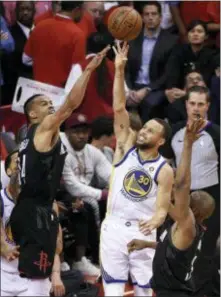  ?? ERIC CHRISTIAN SMITH — THE ASSOCIATED PRESS ?? Golden State’s Stephen Curry (30) shoots as Houston’s Gerald Green, left, and Chris Paul defend during Game 2 of the Western Conference finals Wednesday in Houston.