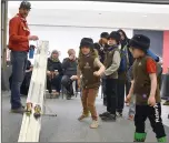  ?? Matthew Liebenberg/Prairie Post ?? Beaver Scouts look on while their buggies speed down the track.