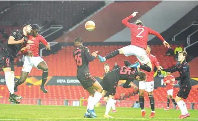  ?? - AFP photo ?? Manchester United's Congo-born English defender Axel Tuanzebe (2L) heads the ball into the net as Swedish defender Victor Lindelof (R top) clatters into Real Sociedad's Spanish forward Jon Bautista during the UEFA Europa League Round of 32, 2nd leg match at Old Trafford in Manchester, on February 25, 2021.