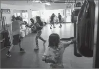  ?? SHAFKAT ANOWAR/DALLAS MORNING NEWS ?? Amanda Alvarez, a neuroscien­tist, salsa teacher and boxing lover, trains Eduardo Soto, left, during a boxing workout on May 2.