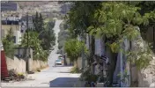  ?? MAJDI MOHAMMED — THE ASSOCIATED PRESS ?? Flowers, flags and other memorabili­a create a makeshift memorial at the site where veteran Palestinia­n-American reporter Shireen Abu Akleh was shot and killed, in the West Bank city of Jenin.