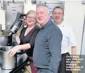  ??  ?? Chris Wells, right with John McCorry and colleague making soup at the foodbank