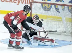  ?? ANDREW VAUGHAN/THE CANADIAN PRESS ?? Ottawa Senators’ Logan Brown, left, is stopped by New Jersey Devils’ goaltender Cory Schneider during third period NHL pre-season hockey action in Summerside, P.E.I., on Monday. New Jersey won 8-1.