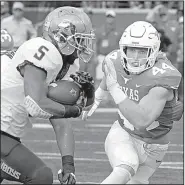  ?? AP/MICHAEL THOMAS ?? (5) tries to run past Texas linebacker Breckyn Hager during the No. 10 Cowboys’ 13-10 overtime victory over the Longhorns on Saturday in Austin, Texas. Hill ran for 117 yards on 33 carries in the victory.