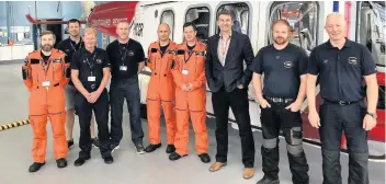  ??  ?? Top crew Brian Whittle MSP with the member of the Search and Rescue team based in Prestwick