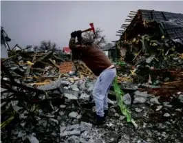  ?? EFREM LUKATSKY/ASSOCIATED PRESS ?? A resident cleared away debris Monday in Kyiv following Russia’s early morning missile attack.