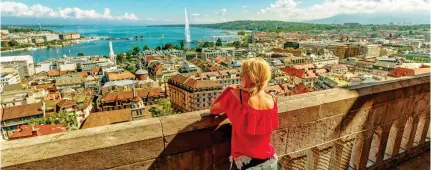  ?? Pictures: BENEDETTA BARBANTI/GETTY ?? Historic: Geneva’s skyline and, inset, a Patek Philippe watch mounted to a wall in the city