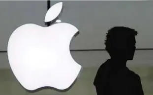  ??  ?? NEW YORK: In this file photo, a person stands near the Apple logo at the company’s store in Grand Central Terminal, in New York. —AP