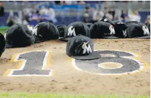  ??  ?? Marlins players leave their ball caps on the pitching mound with the No. 16 painted on it to honour pitcher Jose Fernandez after their game against the Mets on Monday in Miami.