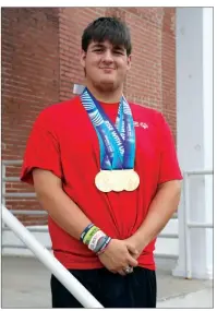  ?? SAM PIERCE/TRILAKES EDITION ?? Alex Smith of Hensley shows off the three gold medals he recently won at the Special Olympics in Seattle.