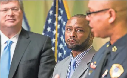  ?? MIKE BROWN/THE COMMERCIAL APPEAL ?? Noble Wray (center), leader of the Department of Justice's Community Oriented Policing Services' initiative, listens to Memphis Police Director Michael Rallings during a news conference Wednesday to discuss the voluntary review of the Memphis Police...
