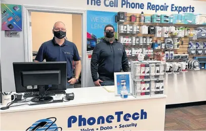  ?? CONTRIBUTE­D ?? Michael Osmond, computer services manager, left, and Gordon Compagnon, service technician, in PhoneTech's new location at the Corner Brook Valley Mall, can fix practicall­y any computer, cellphone, tablet or gaming console issue you may have.