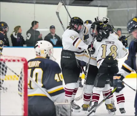  ?? SEAN D. ELLIOT/THE DAY ?? Eastern Connecticu­t Eagles players celebrate a goal against Housatonic/Northweste­rn/Wamogo in high school hockey action Wednesday at Dayton Arena. Visit www.theday.com to see a gallery of photos from the game.