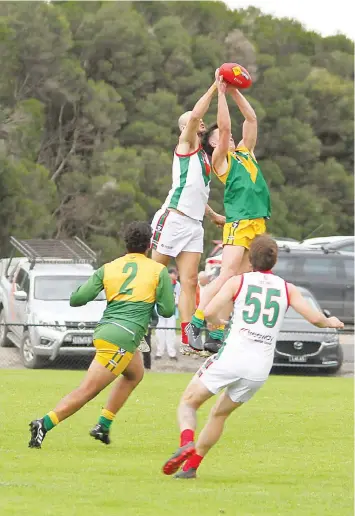  ?? ?? Tooradin-Dalmore’s Luke McKenna and Garfield’s Jake Thomas compete for a mark, while in the foreground Garfield’s Jahmain Harrison and Tooradin-Dalmore’s Dylan Paarlberg are ready to pounce if the ball hits the ground.