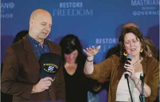  ?? CAROLYN KASTER/AP ?? Pennsylvan­ia Republican gubernator­ial candidate Doug Mastriano and his wife, Rebecca Mastriano, pray on stage during his election night campaign gathering at the Penn Harris Hotel in Camp Hill on Tuesday. Democrat Josh Shapiro easily won the race for governor of Pennsylvan­ia.