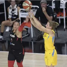  ?? AP ?? DELIVERING LATE: Chicago’s Allie Quigley (right) puts up a shot over Las Vegas’ Kayla McBride on Sunday.