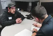  ?? ?? Michael Gileau, left, of Moosup, applying for an outside machinist position, is interviewe­d by Matt White, general foreman of the outside machinist department, during Groton Manufactur­ing Hiring Day at Electric Boat.