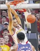  ?? David Purdy / Getty Images ?? Talen Horton-tucker of Iowa State dunks the ball as David Mccormack of Kansas defends.