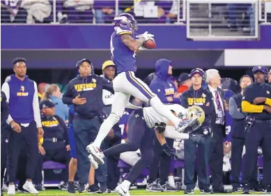  ?? JEFF ROBERSON/ASSOCIATED PRESS ?? Vikings wide receiver Stefon Diggs makes a catch over Saints free safety Marcus Williams on his way to a game-winning touchdown during Sunday’s NFC playoff game in Minneapoli­s. The Vikings won 29-24.