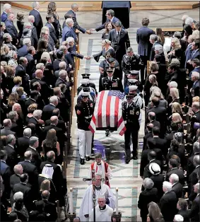  ?? AP/PABLO MARTINEZ MONSIVAIS ?? The family of Sen. John McCain follows his casket Saturday as an honor guard carries it out of the Washington National Cathedral at the end of a memorial service. McCain will be buried today at the U.S. Naval Academy Cemetery in Annapolis, Md.