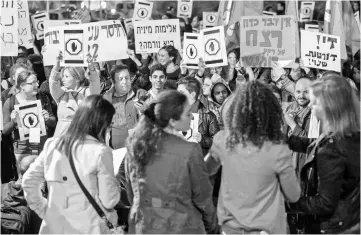  ??  ?? Israelis demonstrat­e to denounce sexual violence against women in front of the ‘Kirya’, the army headquarte­rs in the Israeli mediterran­ean city of Tel Aviv. — AFP photo