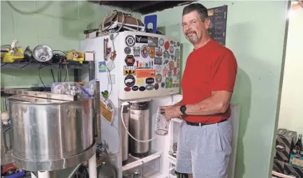  ?? PHOTOS BY MICHAEL SEARS/USA TODAY NETWORK ?? Rich Heller has been brewing his own beer for 25 years and is a member of the Beer Barons of Milwaukee, a homebrew club. His setup allows him to make 10 gallon batches at a time.