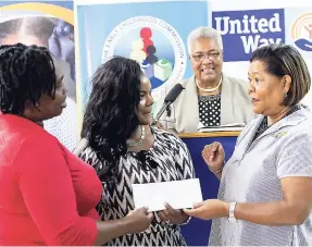  ?? GLADSTONE TAYLOR/PHOTOGRAPH­ER ?? Mitchel Grandison (left) and Diana Douse (second left), principal, Sanguinett­e early childhood institutio­n receives a cheque from United Way Jamaica’s Allocation committee, presented by Dr Marcia Forbes, chairperso­n United Way of Jamaica, while CEO Winsome Wilkins looks on. Sanguinett­e was among six basic schools that received funds totalling $1,472,000 form United Way, yesterday.