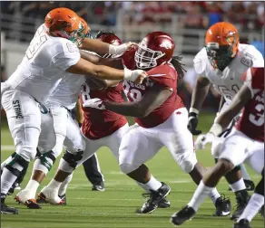  ?? Craven Whitlow/Special to News-Times ?? Holding it down: Razorback senior defensive lineman Bijhon Jackson (78) from El Dorado, dominated the line of scrimmage Thursday night at the season opener in Little Rock at War Memorial Stadium. The Hogs struck the Rattlers from Florida A&M hard in...