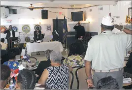  ?? STAFF PHOTOS BY JOHNATHON CLINKSCALE­S ?? Above left, American Legion Randolph Furey Post 170 Commander Allen McKenzie, left, reads a handout while Auxiliary Unit 170 chairwoman Mayvee Smith speaks to a group of Legionnair­es during the Post’s second annual POW/MIA recognitio­n ceremony on Saturday in Indian Head. Above right, American Legion Post 233 Southern Maryland District service officer Leon Parks, far right, joins Post 170 adjutant Dyotha Sweat and commander Allen McKenzie in saluting fallen and missing service members while an Auxiliary Unit 170 member places a U.S. Marine Corps service cap on the POW/MIA table during Saturday’s recognitio­n ceremony. Below left, Chante Renee Butler, center, smiles as she prepares to receive an honorary service citation from the American Legion in recognitio­n of her father, Cpl. Dewey Renee Butler, who has been missing in action since 1969 during the Vietnam War. Chante also received a POW/MIA event pin. Below right, family members stand with Janice Brooks, sister of Pfc. Francis DeSales Wills from La Plata who has been missing in action since 1966 during the Vietnam War, as she speaks to a small crowd during the POW/MIA recognitio­n ceremony.