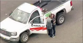  ?? KTLA ?? AFTER LEADING police on a chase Wednesday through southwest L.A. County, the driver and passenger of a stolen U-Haul truck were taken into custody.