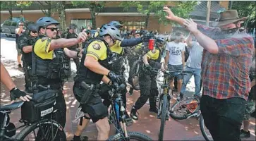  ?? DAVE KILLEN Oregonian ?? CITY LEADERS plan a major law enforcemen­t presence on Saturday. Similar rallies have turned violent.