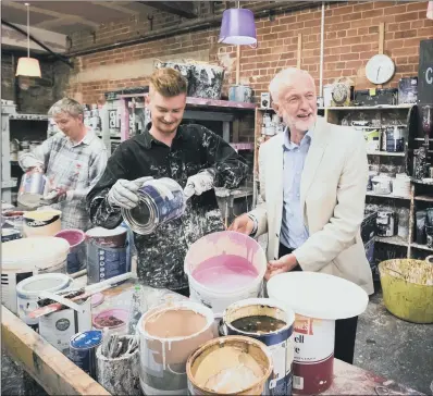  ??  ?? PITCHING IN: Jeremy Corbyn during a visit to Seagulls Reuse in Leeds, which was damaged during the Boxing Day floods in 2015. PICTURE: PA