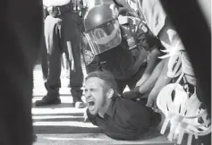  ??  ?? Occupy Wall Street protester Chris Philips screams as he is arrested Monday near Zuccotti Park in New York. Multiple Occupy Wall Street protesters were arrested during a march toward the New York Stock Exchange on the anniversar­y of the grass-roots...