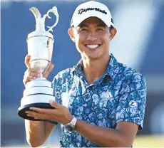  ?? — AFP photo ?? Morikawa poses for pictures with the Claret Jug, the trophy for the Champion Golfer of the Year, after winning the 149th British Open Golf Championsh­ip at Royal St George’s, Sandwich in south-east England.