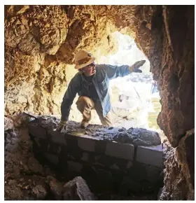  ??  ?? Rohrer, with the Utah Division of Oil, Gas and Mining, climbs in to a cave before its sealed off near Gold Hill, Utah. For the state, the message is clear: Stay out and stay alive. The programme has been around more than 30 years, and the division has sealed some 6,000 abandoned mines.