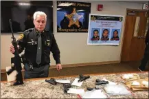  ?? STAFF ?? Montgomery County Sheriff Phil Plummer shows guns and drugs seized during raids at four different locations in Trotwood and Dayton on Wednesday.