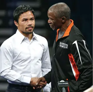  ?? ASSOCIATED PRESS ?? Manny Pacquiao, left, shakes hands with Floyd Mayweather Sr. during a press conference following their welterweig­ht title fight in Las Vegas. Mayweather defeated Pacquiao in a unanimous decision.