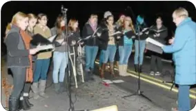  ?? Photo by Jeff Goldberg ?? The Pennsbury Falconaire­s add to the festive holiday mood at the Yardley tree lighting ceremony on Friday.