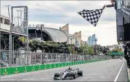  ?? AFP ?? ■ Mercedes' Lewis Hamilton wins in Baku after leader Valtteri Bottas suffered a late puncture. Win helped Hamilton top drivers’ standings.