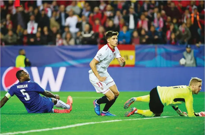  ?? — AFP ?? SEVILLA: Sevilla’s Argentinia­n midfielder Joaquin Correa (C) celebrates after scoring a goal during the UEFA Champions League round of 16 second leg football match Sevilla FC vs Leicester City at the Ramon Sanchez Pizjuan stadium in Sevilla yesterday.