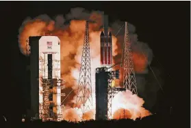  ?? John Raoux / Associated Press ?? A 23-story Delta IV Heavy rocket carrying the compact Parker Solar Probe lifts off from Kennedy Space Center on Sunday in Cape Canaveral, Fla.