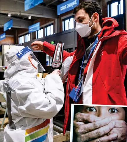  ?? ?? Wall of steel: A Swiss athlete is scanned at the Olympic village this week. Right: Protest against Games over China’s treatment of Uighur