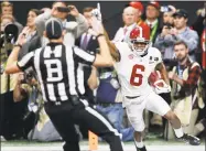  ?? Joshua L. Jones / Associated Press ?? Alabama wide receiver DeVonta Smith celebrates after scoring the game-winning touchdown during overtime of last season’s NCAA college football playoff championsh­ip game against Georgia in Atlanta.