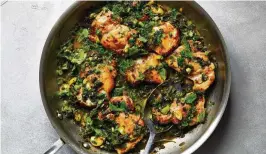  ?? YORK TIMES ARMANDO RAFAEL / THE NEW ?? Herby skillet chicken with greens. This forgiving and adaptable weeknight dinner stars tender chicken thighs, braising greens and whole garlic cloves.
