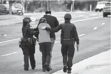  ?? Helen H. Richardson, The Denver Post ?? People who were inside the King Soopers during the shooting are escorted down the street by Boulder police.