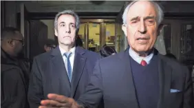  ?? SPENCER PLATT/GETTY IMAGES ?? Former Donald Trump lawyer Michael Cohen, left, walks out of a Manhattan courthouse after testifying before a grand jury on Monday in New York City.