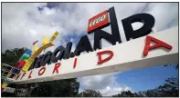  ??  ?? In this 2011 file photo, a worker puts finishing touches on the entrance sign at Legoland Florida in Winter Haven, Fla. The Legoland theme park in Florida is installing tents over the entirety of its MiniLand USA … tiny versions of American cities and landmarks. (AP Photo/John Raoux)